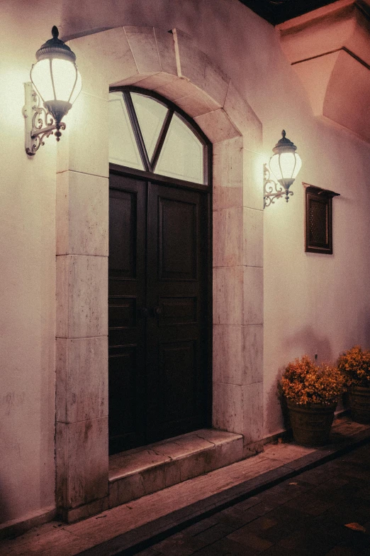 two lanterns light up the entrance to a home