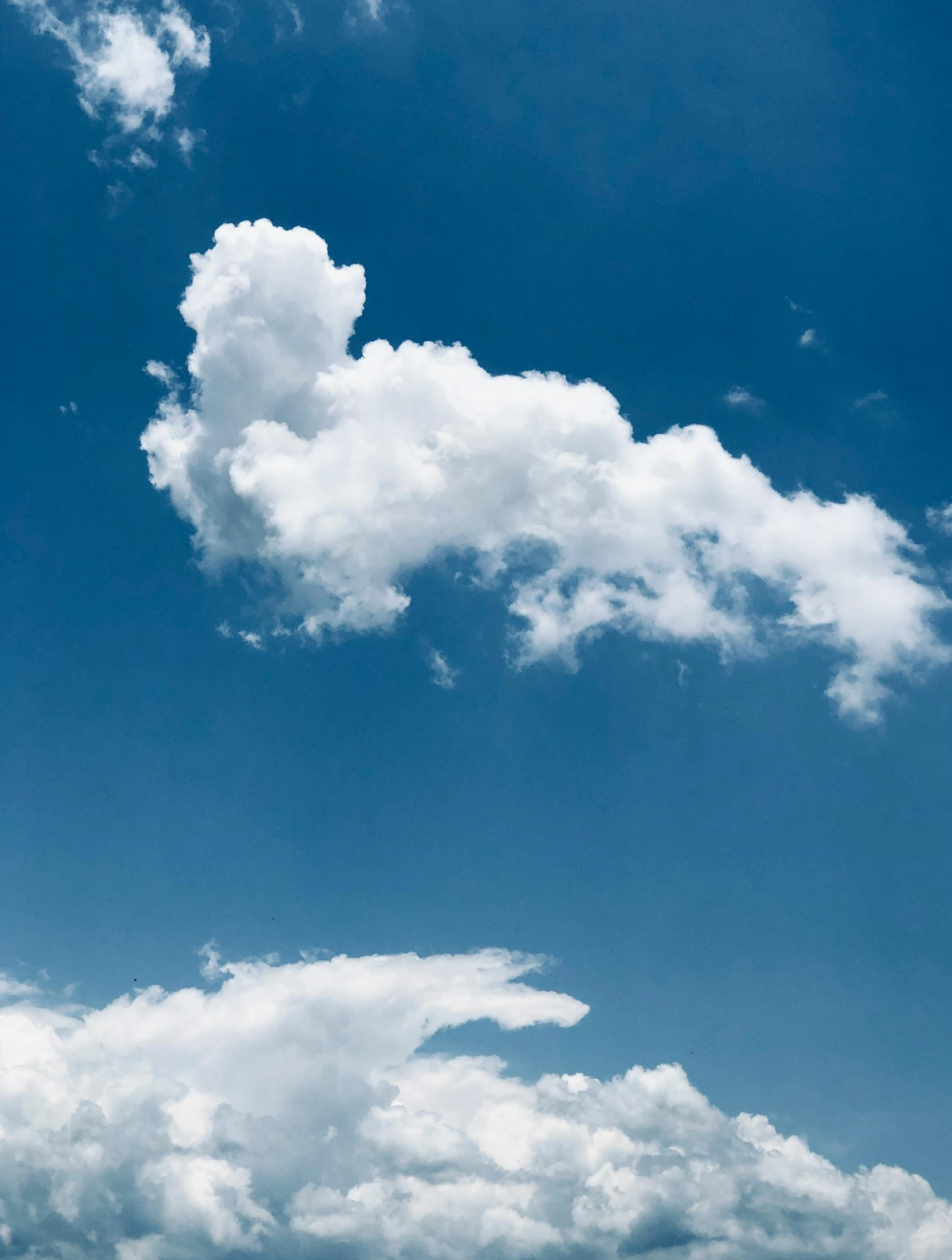 some clouds in a deep blue sky