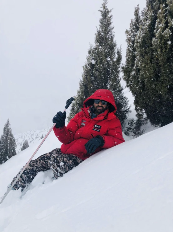 a person is snowboarding down a hill wearing a red coat