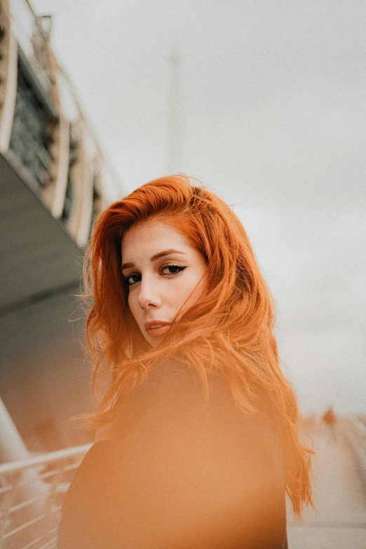 a woman with orange hair in the sunlight