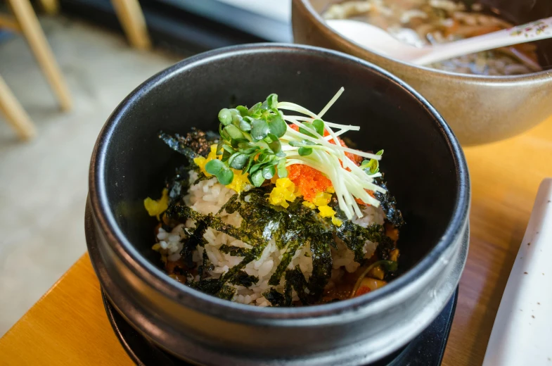 a bowl filled with food next to another dish