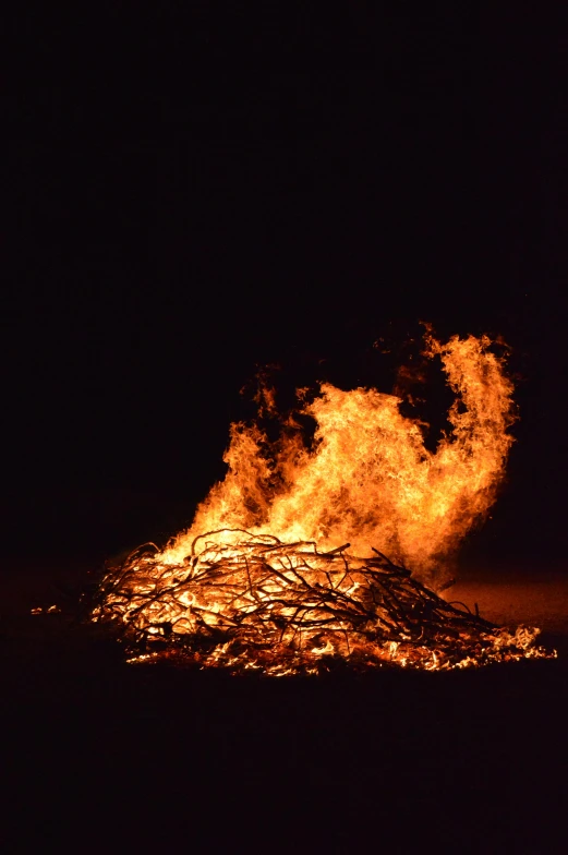 the fire is going into a pile of logs