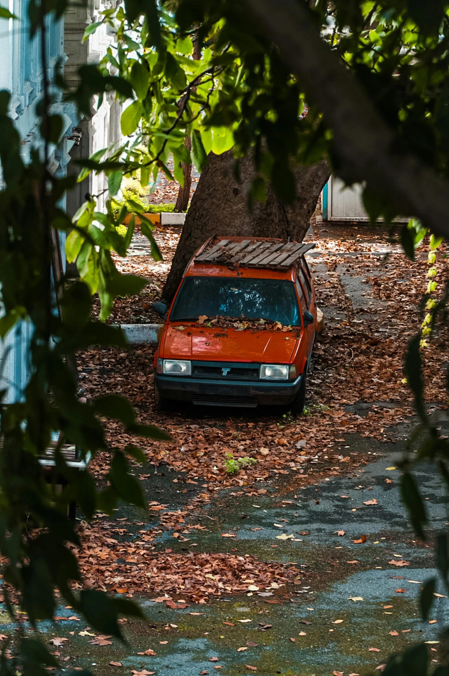 a red car is parked in the middle of a driveway