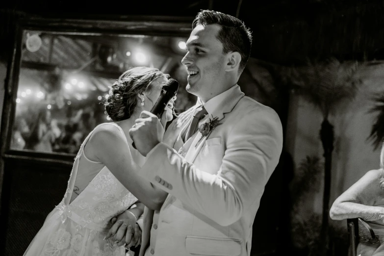 a man and woman dancing on stage at a wedding