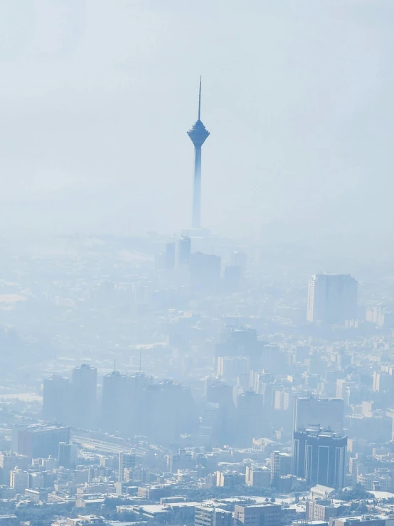 fog over the city skyline and a large observation tower