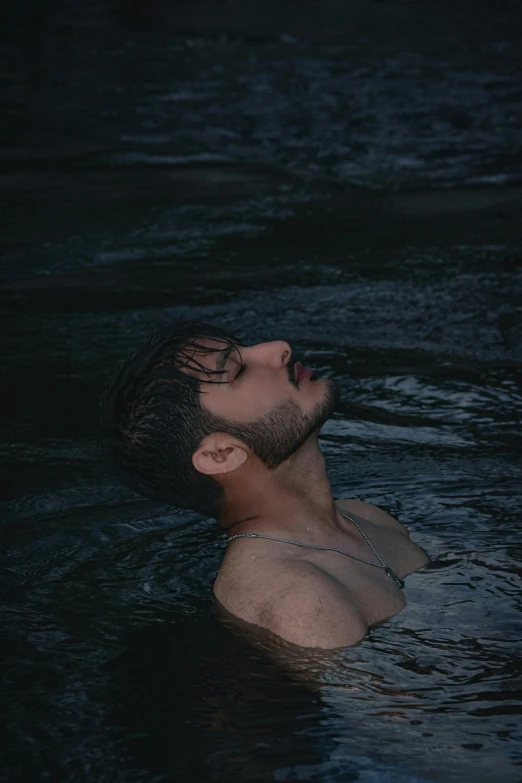 man floating in the dark water, 