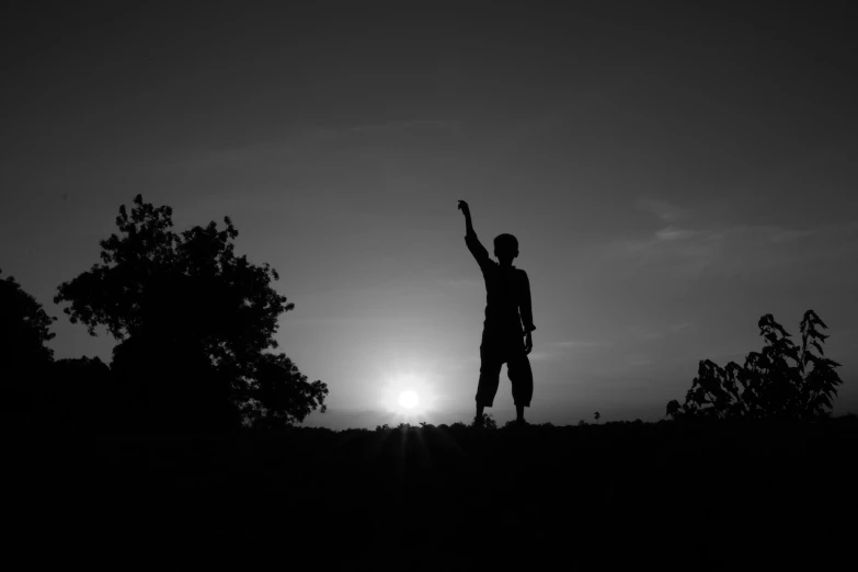 a man standing on top of a lush green hillside