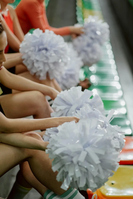 group of cheerleader sitting down for a game