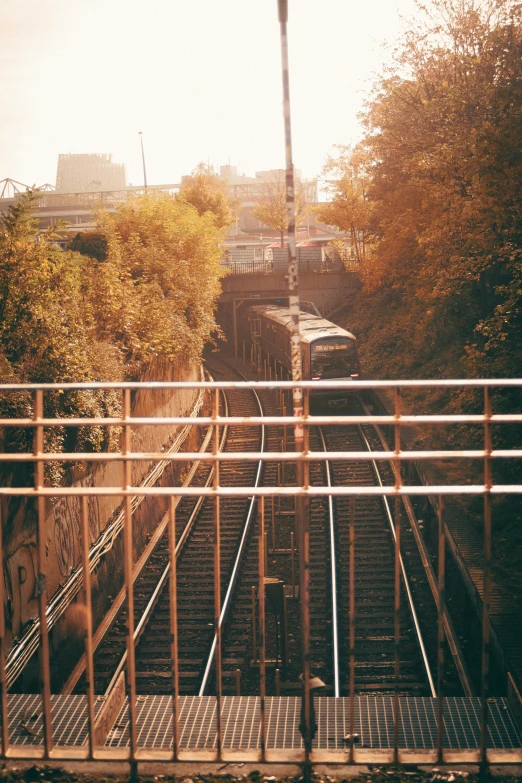 a small rail yard with an old train going down the track