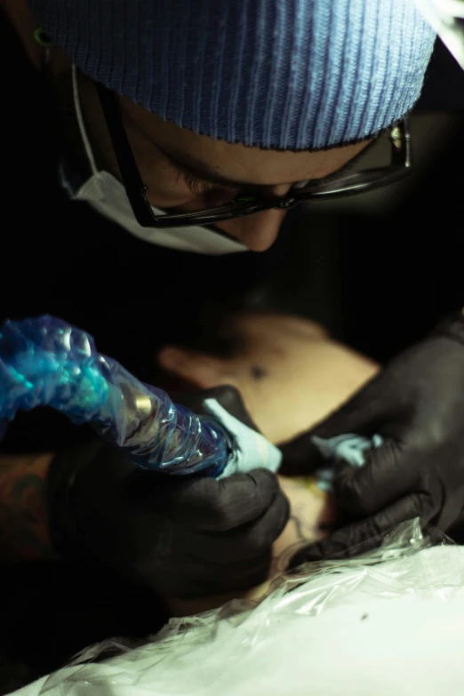 a man getting some kind of tattoo on his arm