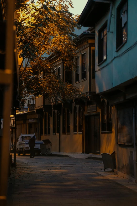 an empty city street at night with the sun going down