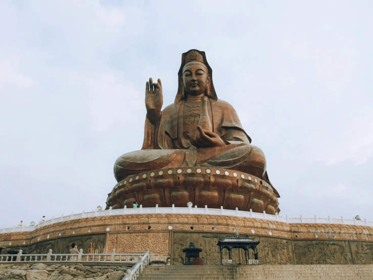 there is a large buddha statue that has a lot of stairs to it