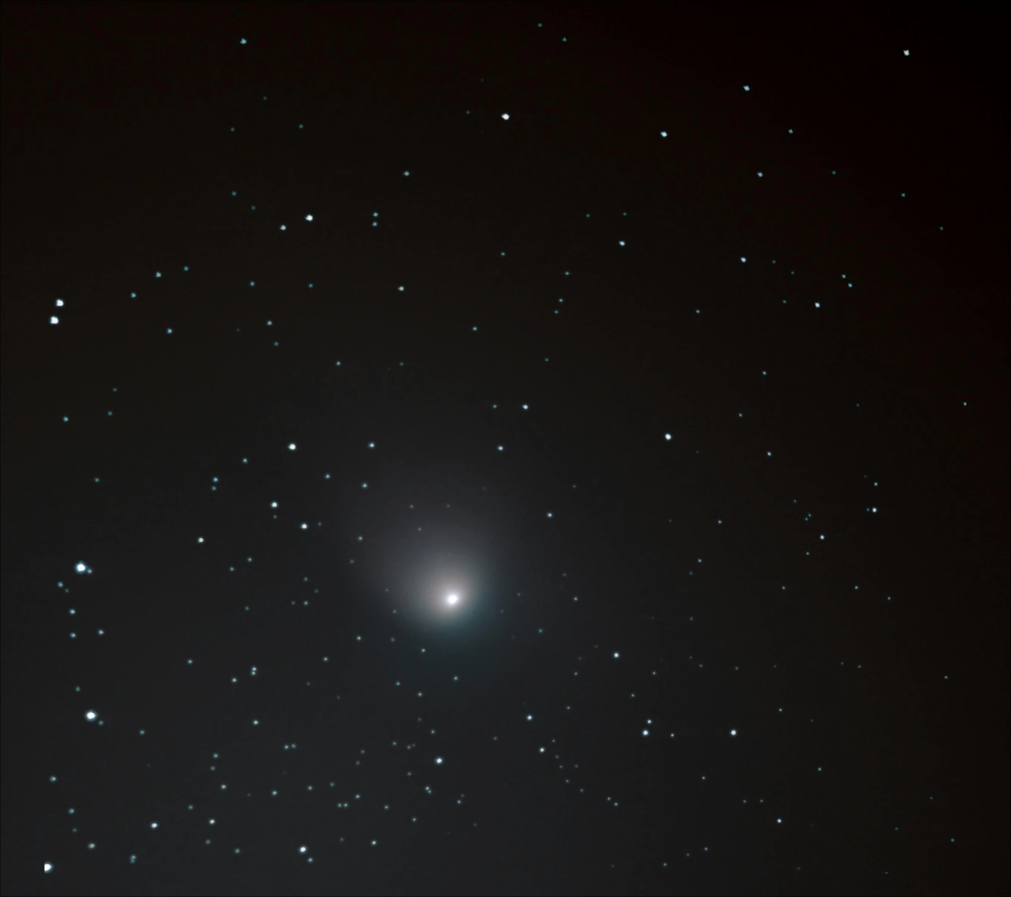 bright blue glow in the black sky as stars move across