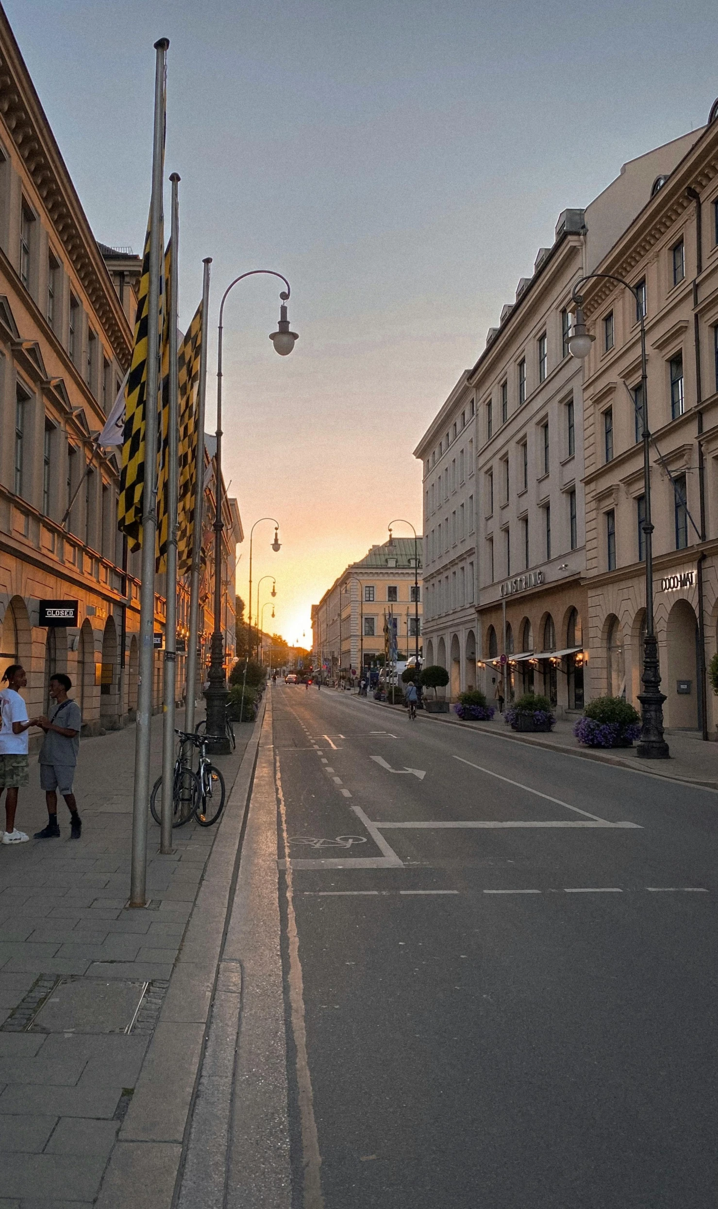 a man is walking down a street by the buildings