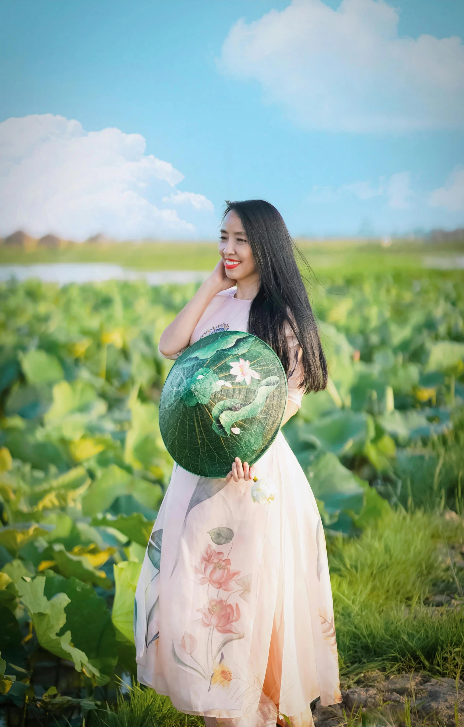 a woman posing in a field with a large pot