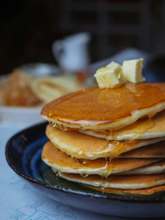 pancakes are piled high and on a plate with er