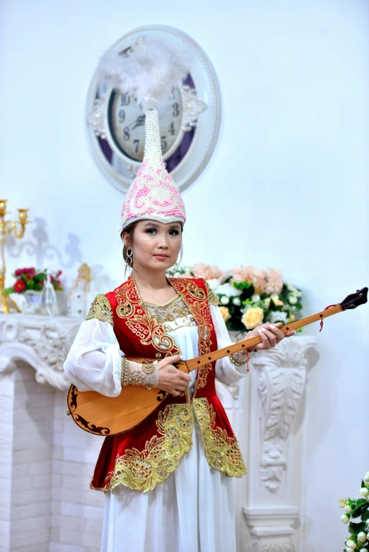 a woman dressed in folk garb playing a lute