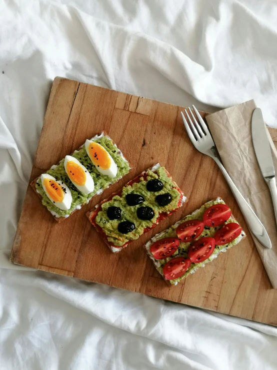 a wooden  board topped with sliced up veggies