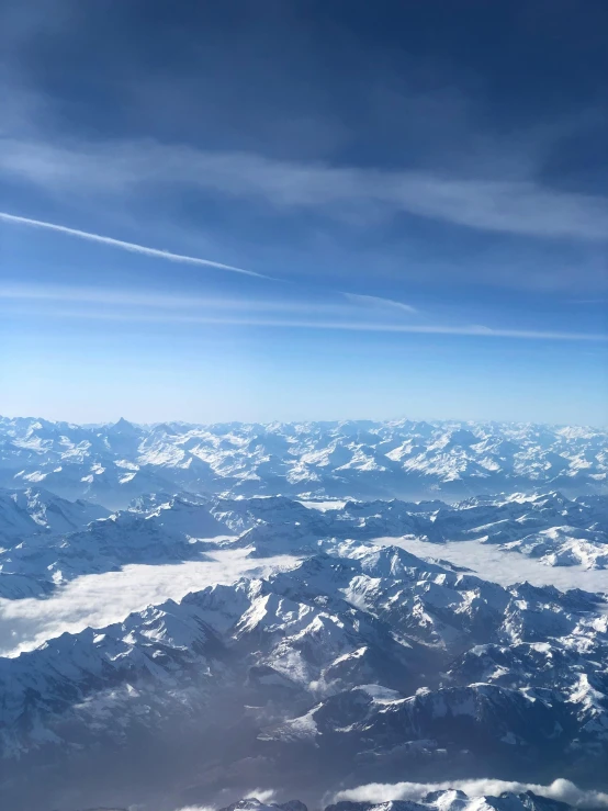 snow capped mountains that are under a blue sky