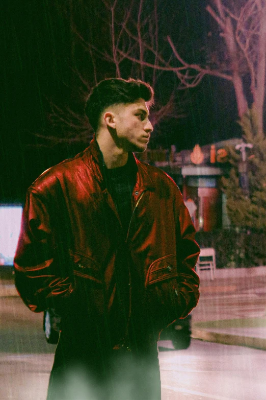a man with a beard in a red leather jacket