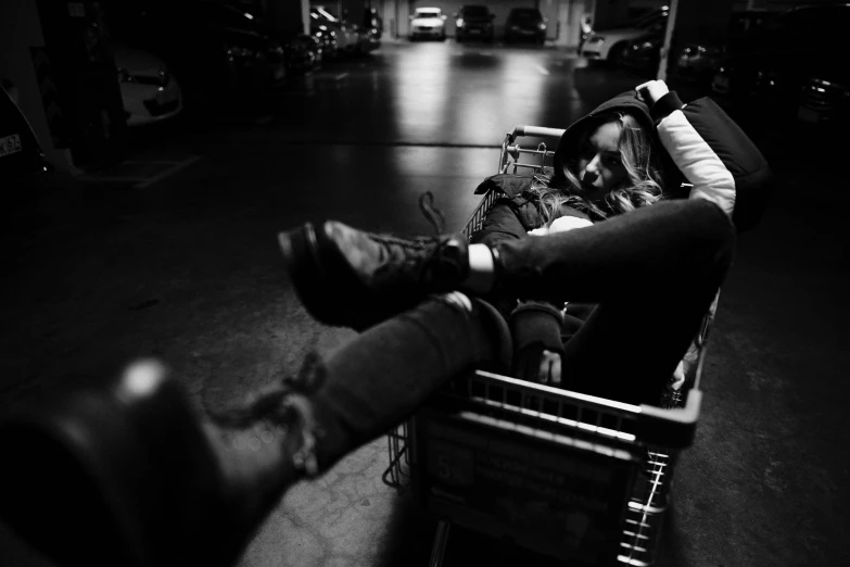 a man is sitting in a shopping cart