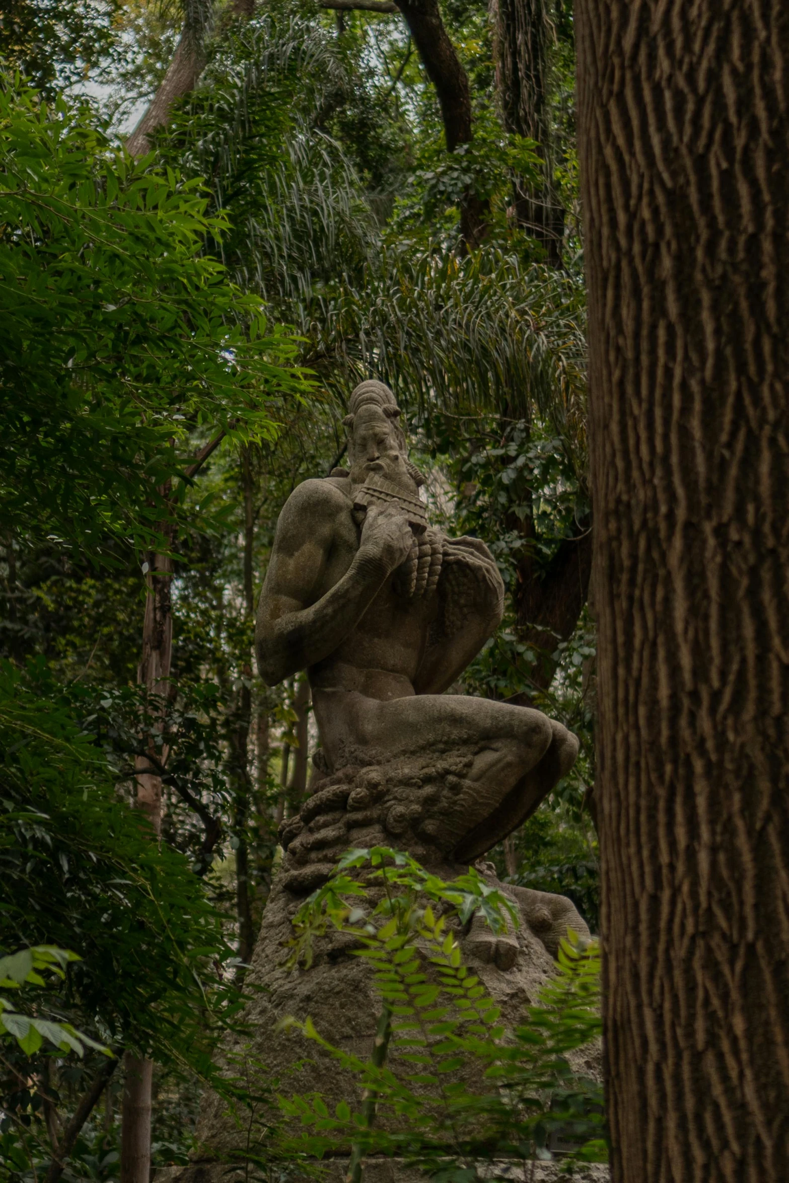 an elephant statue in the middle of a forest