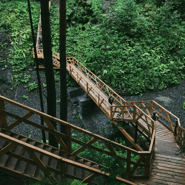 steps lead up to an outdoor play area with trees