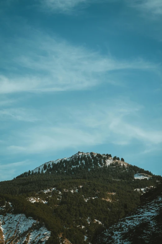 the mountain is very high on the slope under the blue sky