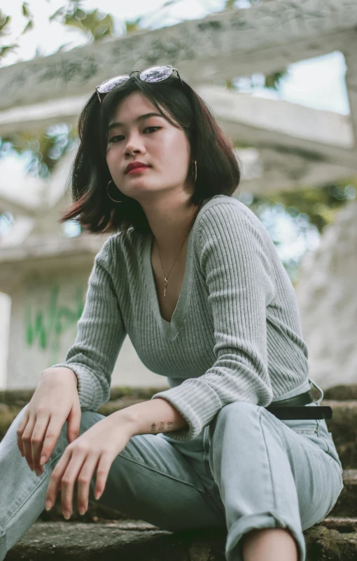 a woman sitting on some steps and leaning against her