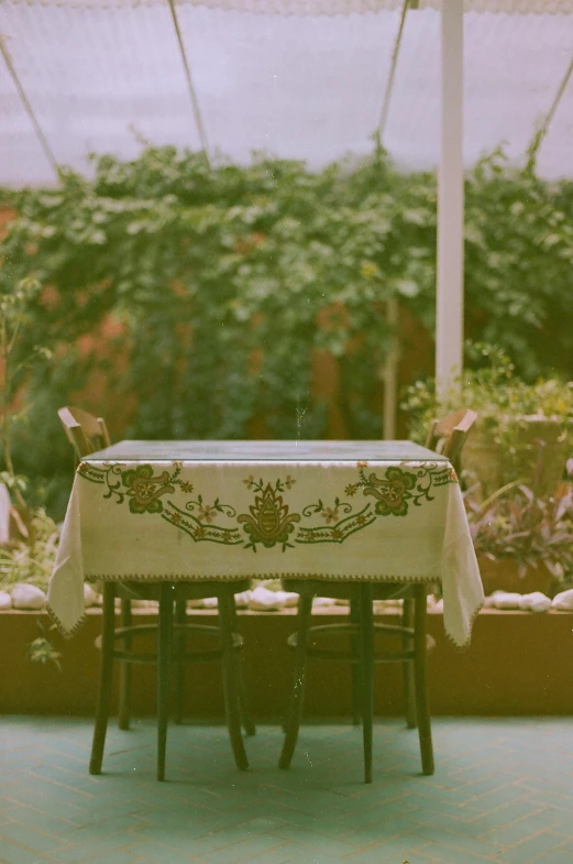 a table covered with a white cloth with some animals behind it