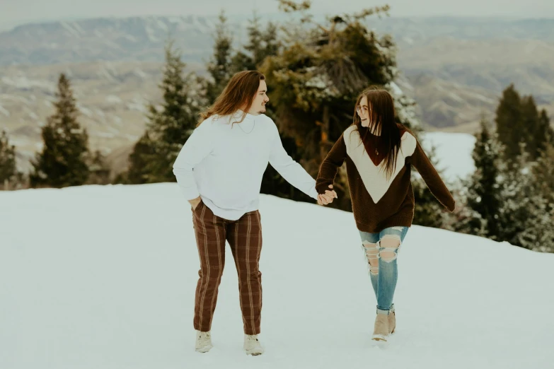 two girls on a hill holding hands