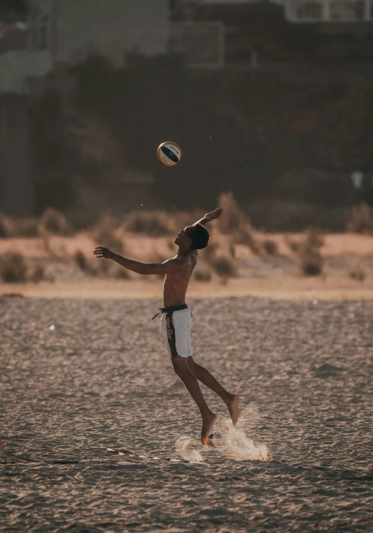 the man is playing with a ball on the water