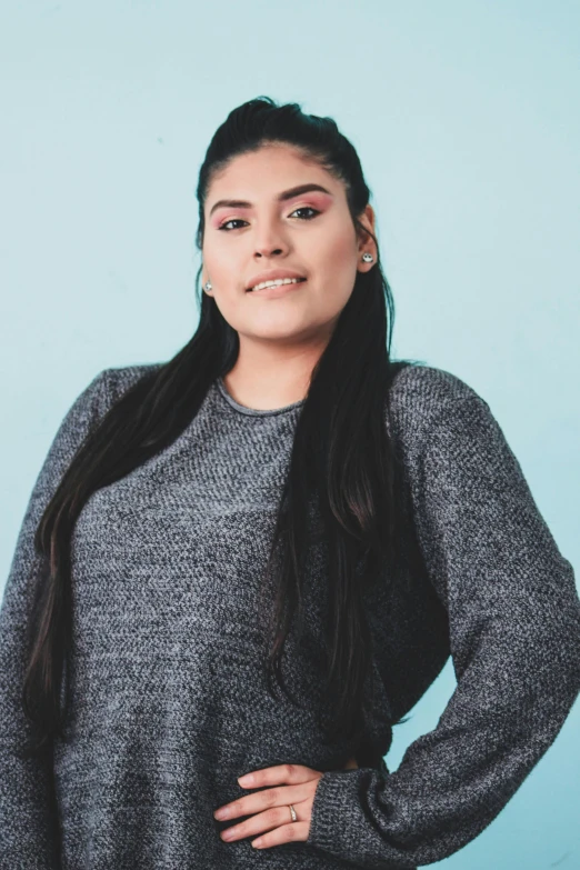 the young woman is posing in the studio