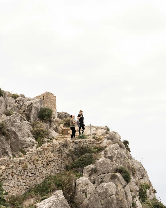 two people walking up steps in a mountain