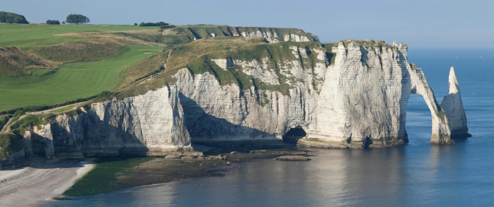 a big hill on a small shore near the water