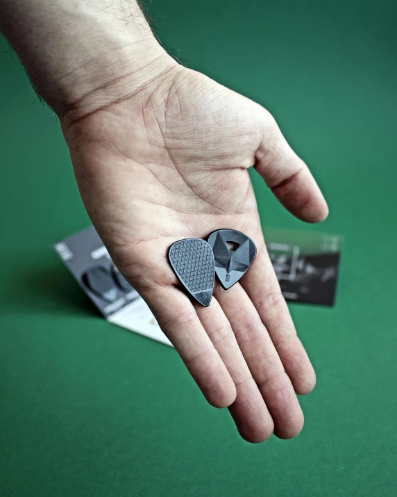 a close up view of a person's hand holding an elephant brooch