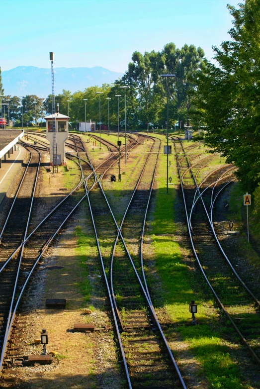 multiple train tracks with a building in the back