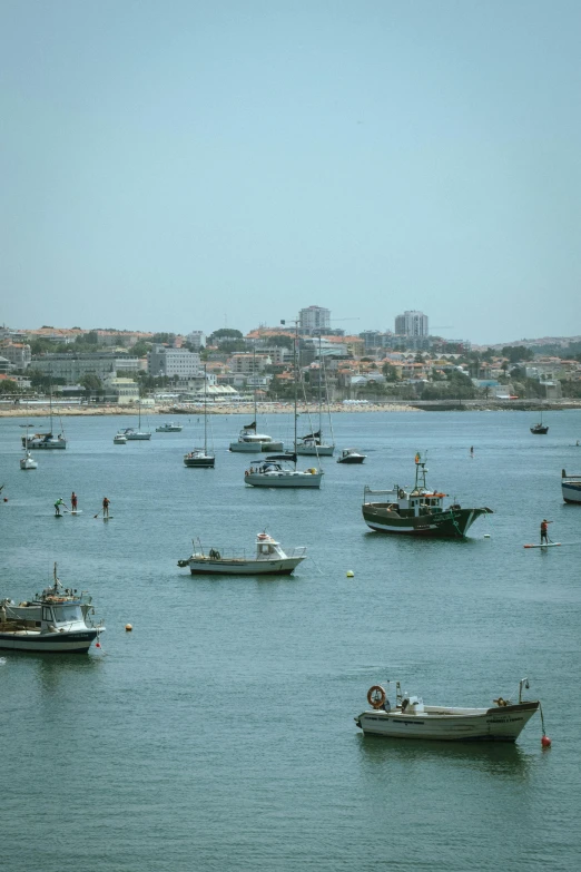 several boats that are in the water by shore