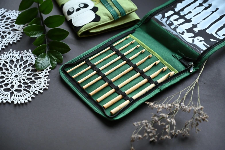 some green and white bags next to flowers on a table