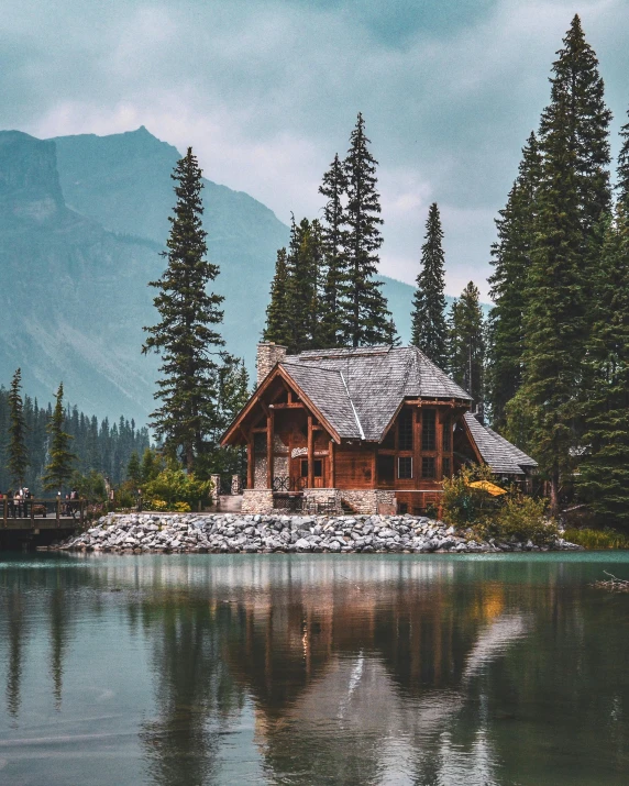 a log house on an island sits in the water