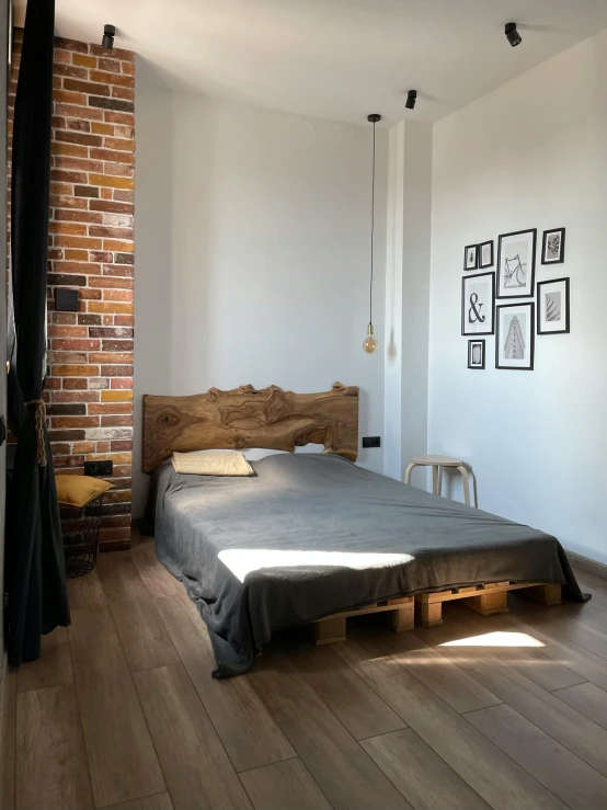 a bed that is in the middle of a wooden floor