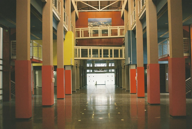 the hall inside the building has a long number of pillars