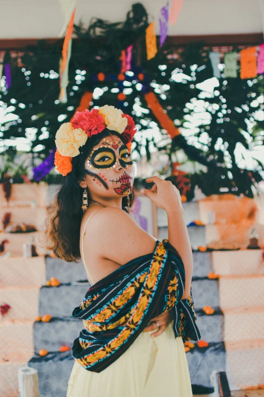 a woman wearing a dress and flower headgear