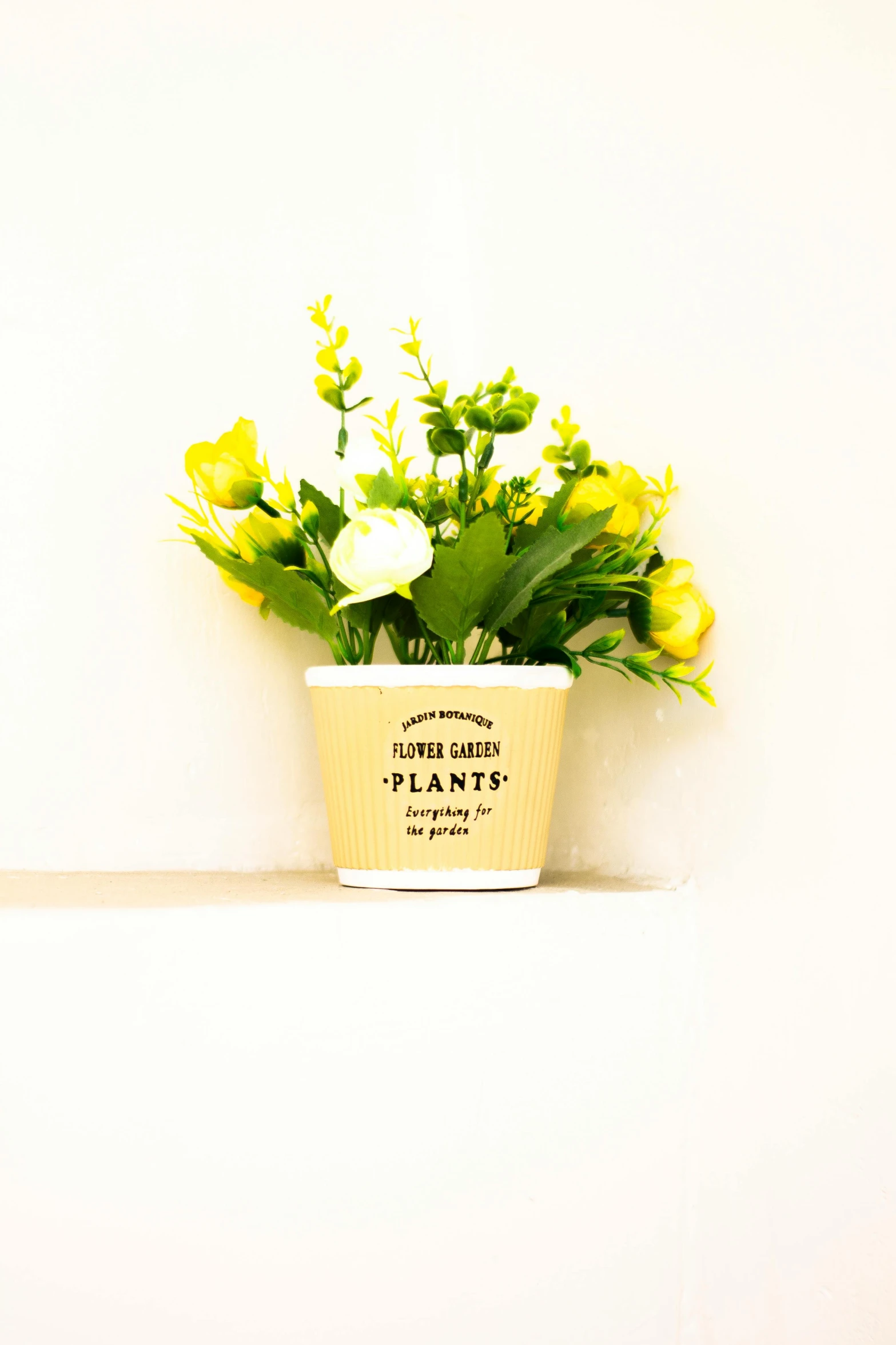 a potted plant on a shelf with yellow flowers