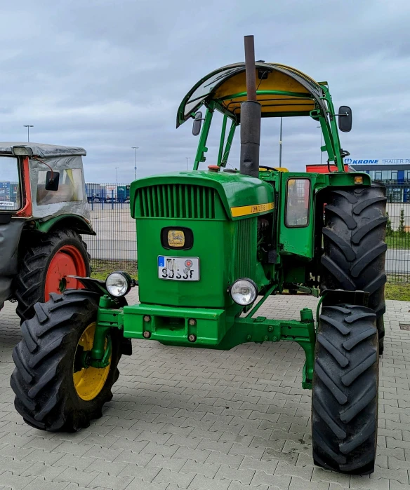 an antique tractor and tractor mounted to each other