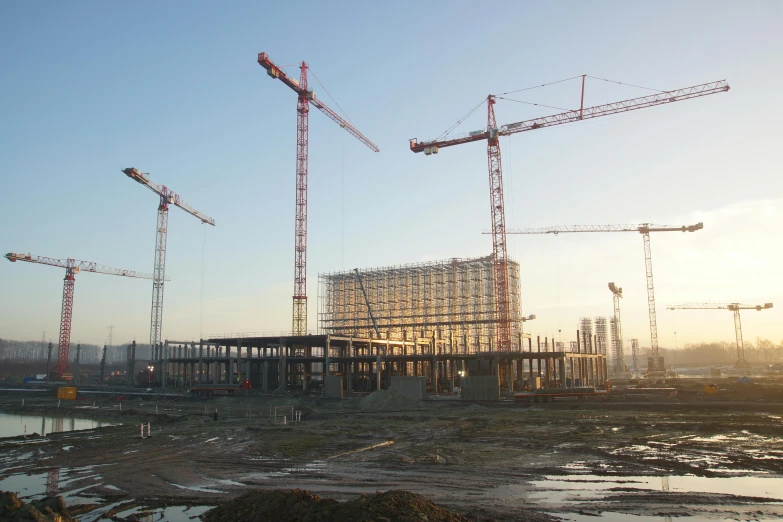 a construction site with large cranes in the air