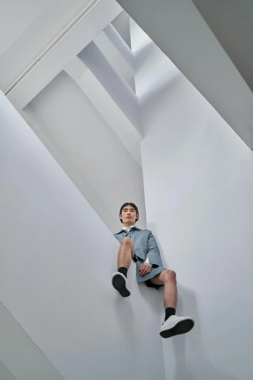 a person is sitting down on the floor and posing