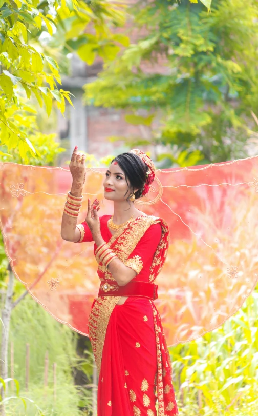 a woman in red with a veil on her head