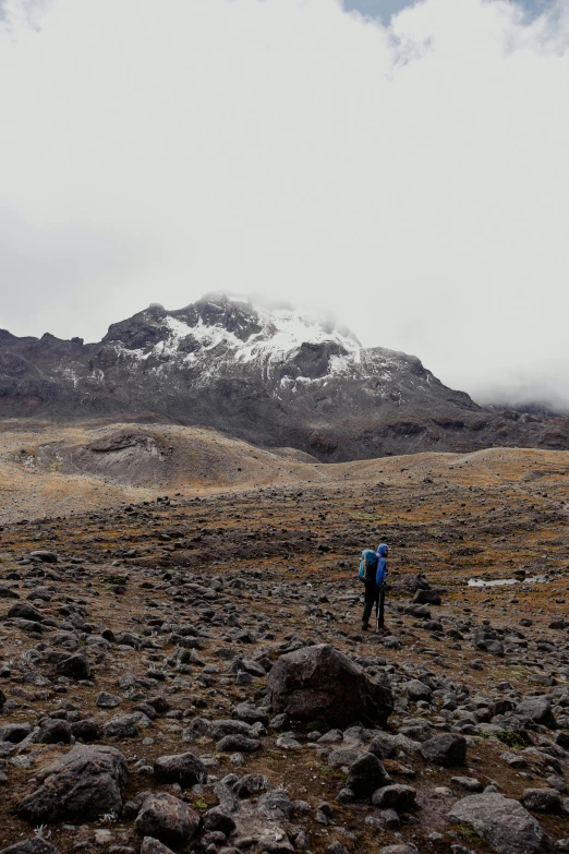 a couple hikes through the rocky terrain towards a mountain