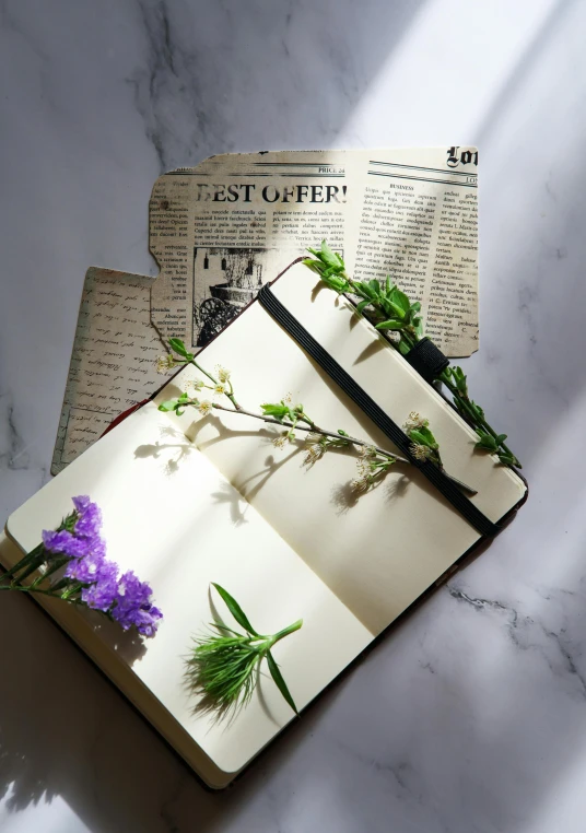 a book with some flowers sitting on it